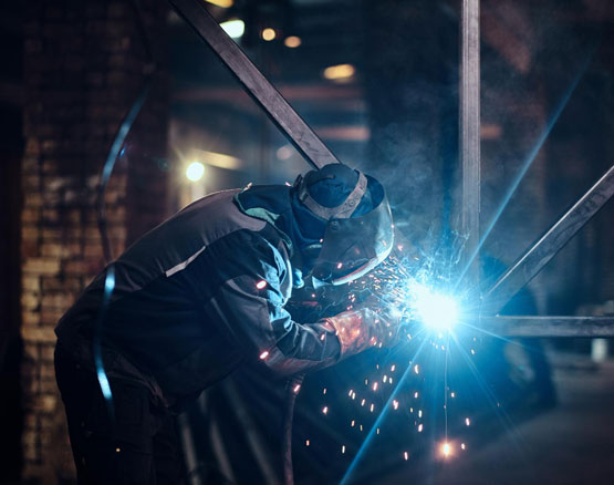 Welding work with metal construction at busy metal factory